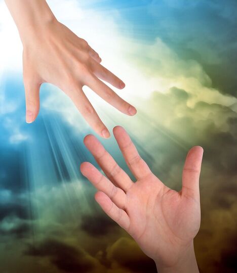 Hand reaching from earth to a hand reaching down from heaven.